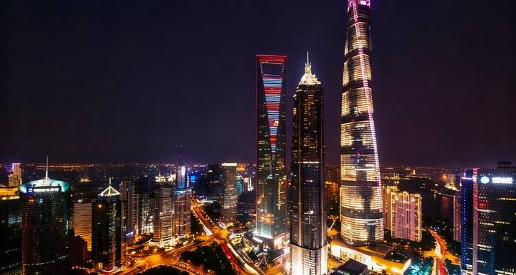 City skyline at night with illuminated skyscrapers.
