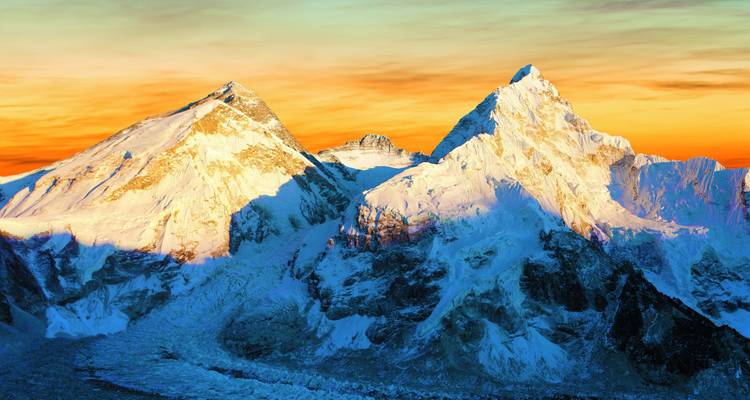 Snow-covered mountains at sunset.
