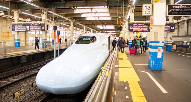 A sleek high-speed train at a station platform.
