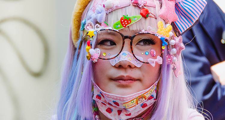A person wearing colorful and decorated Harajuku-style fashion.