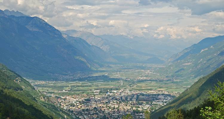 Valley view with a town nestled among mountains.