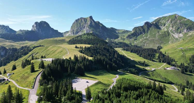 Expansive landscape of green hills and mountainous terrain.