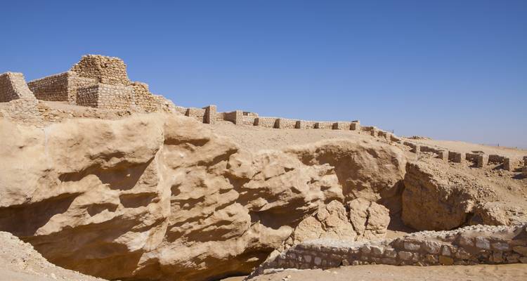 Ruins of a fort-like structure in a desert setting.