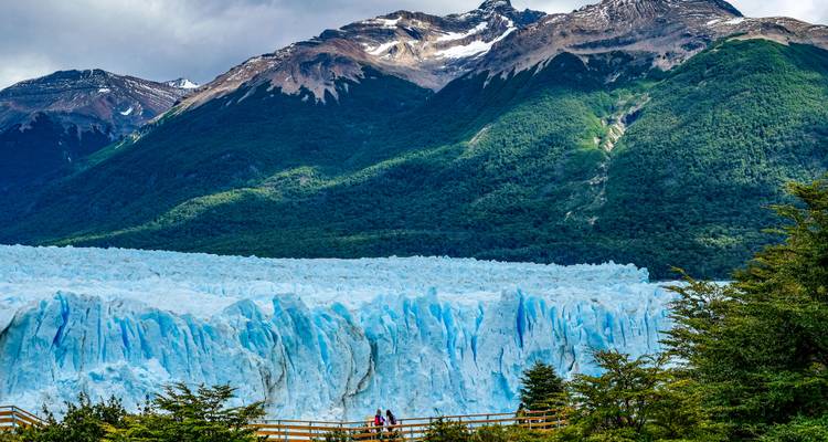 Expansive glacier with mountains and clouds.
