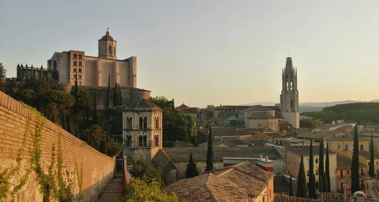 Historic stone buildings and cathedral in a European city.