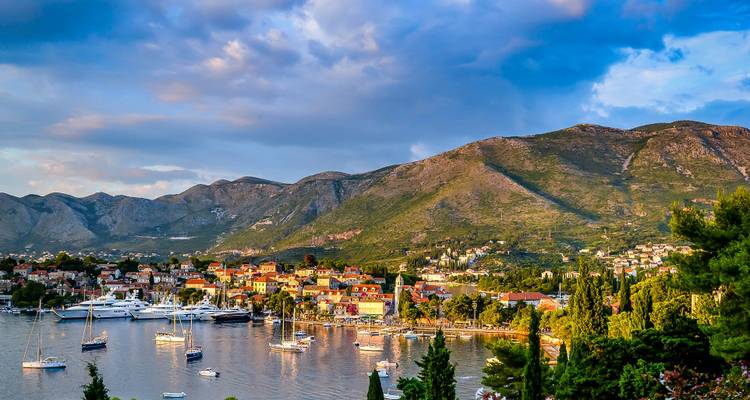 A coastal town with colorful buildings and boats docked at the marina.