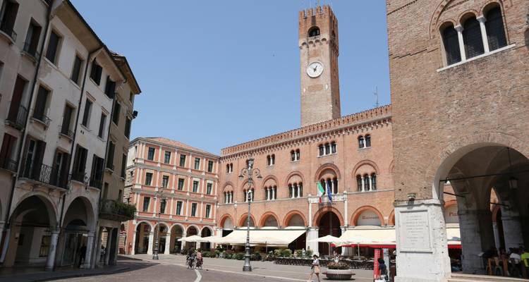 Historical square with a clock tower in Treviso.