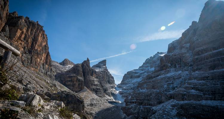 Paisaje montañoso con formaciones rocosas y nieve.