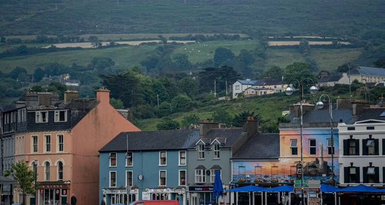 Colorful townhouses with hills in the background