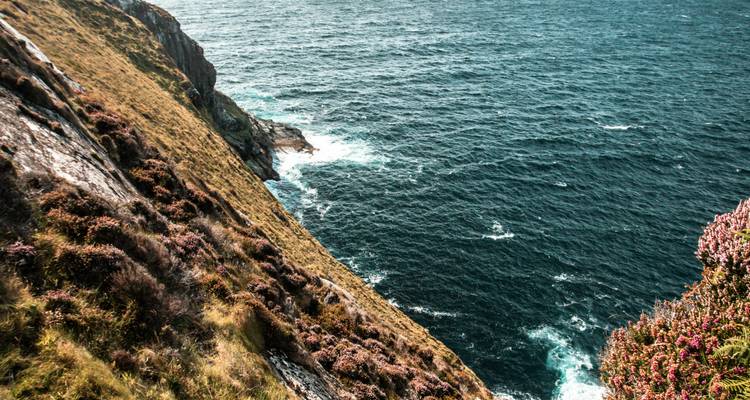 Steep coastal cliffs with ocean waves