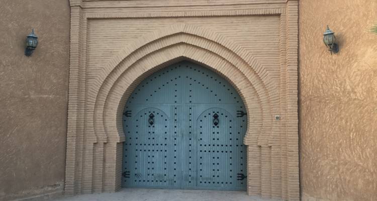 Traditional arched door in a brick wall.