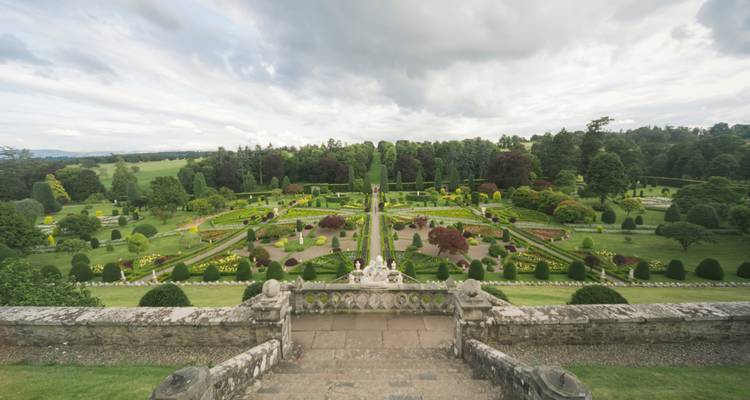 Expansive formal garden with manicured hedges and flowerbeds.