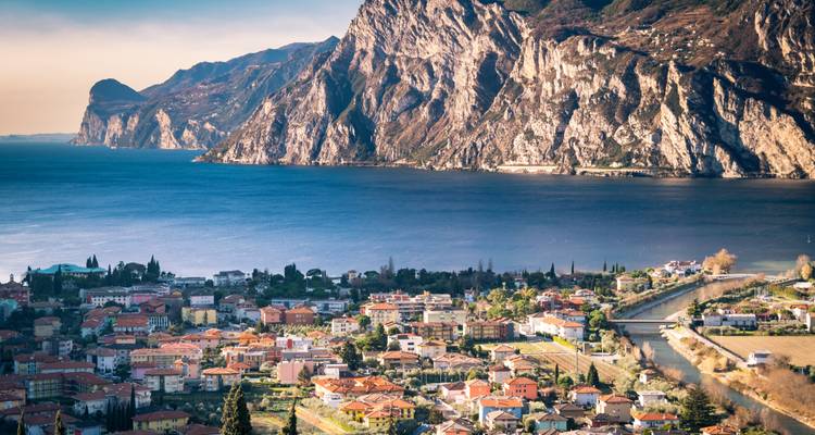 Scenic view of mountains and a town near the water.