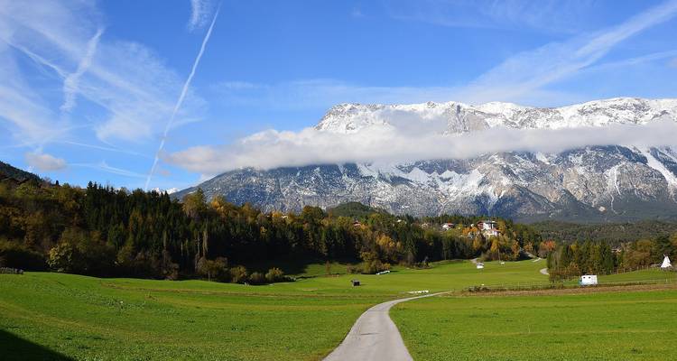 A picturesque valley with a snow-capped mountain in the background.