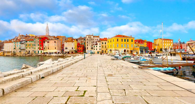 Colorful coastal buildings along a pier.