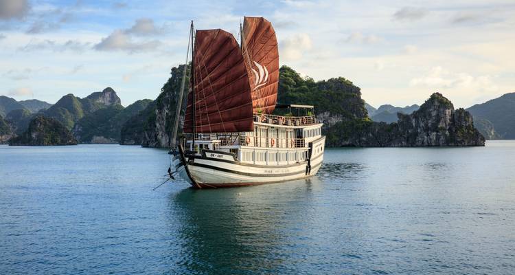 A traditional Asian junk boat sailing in Halong Bay.