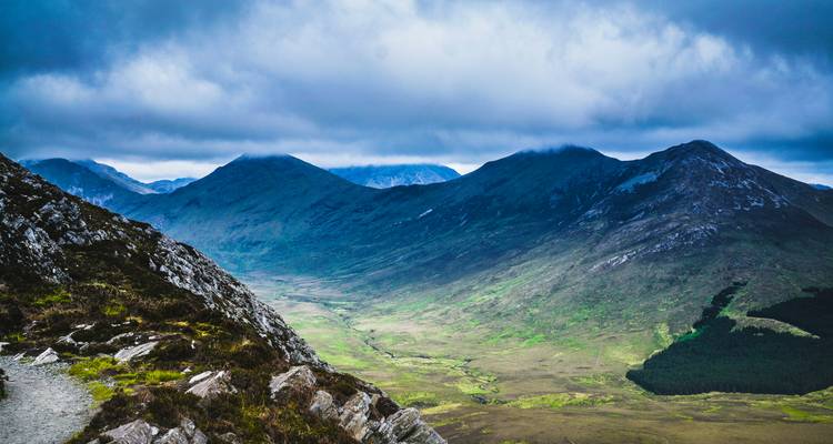 Valley surrounded by mountains with a moody atmosphere.