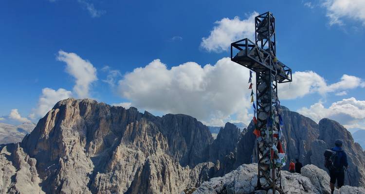 Mountain scenery with a large cross and clouds.