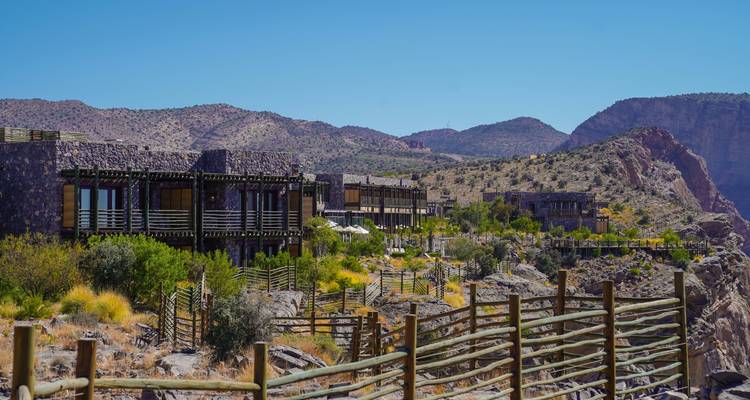 Rustic buildings in a rocky landscape.