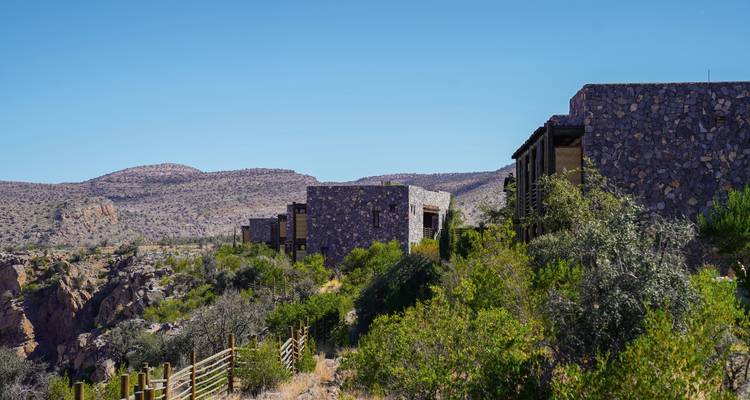 Rocky desert landscape with scattered buildings.