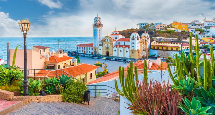 Picturesque coastal town with a church and ocean in the background.