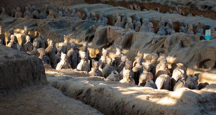 Terracotta Army lined in excavated pits with natural light.