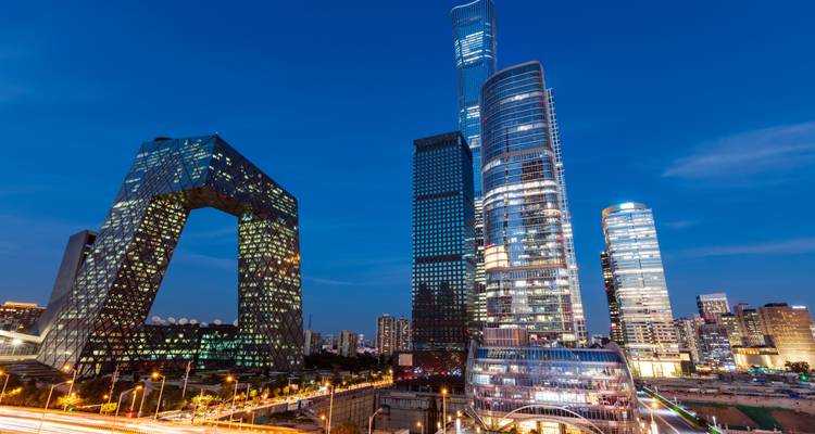 Beijing skyline at night with modern architecture under blue skies.