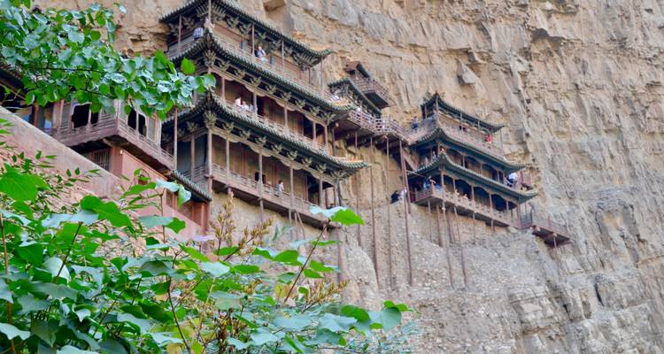 Hanging Temple built into a cliff face with surrounding trees.
