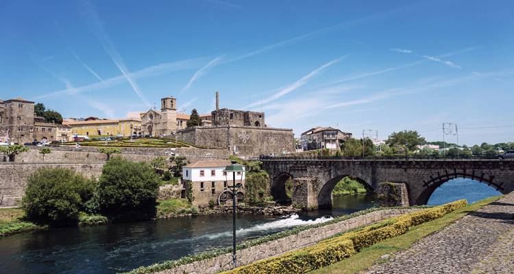 Scenic view of a town with a bridge and river.