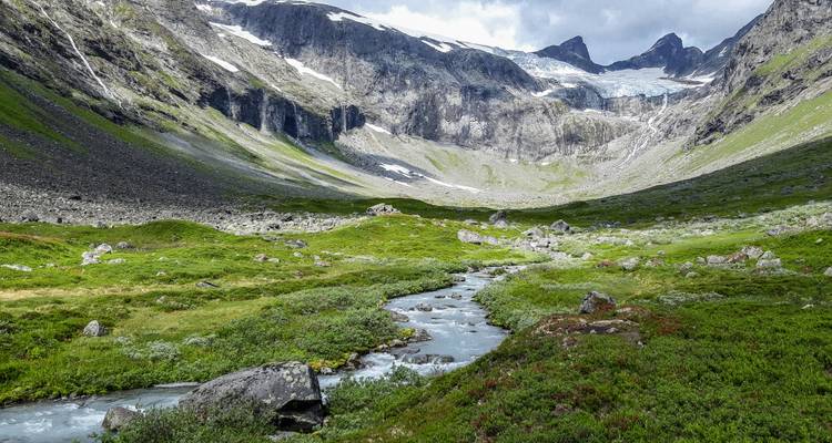 Valley with stream and rocky mountains.