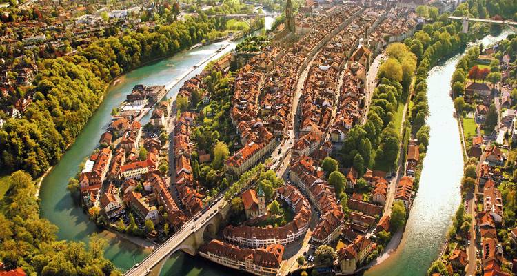 Aerial view of a medieval town with a river winding through.