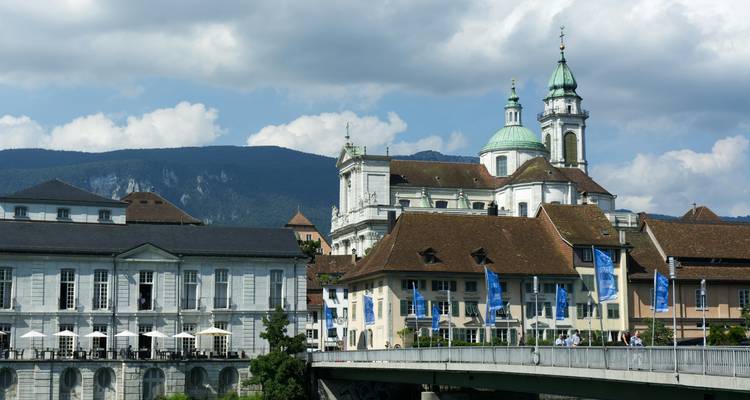 Scenic view of a city featuring classic architecture and a river.