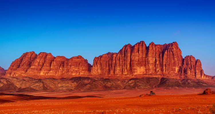 Majestic red sandstone formations in Wadi Rum desert, Jordan during sunset.