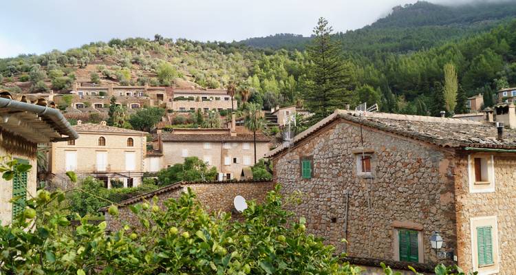 Traditional stone houses in a mountainous village setting.