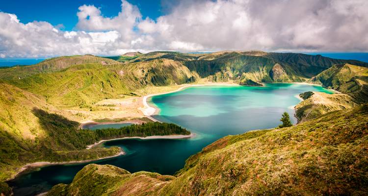 Laguna vibrante con colinas verdes en una caldera volcánica.
