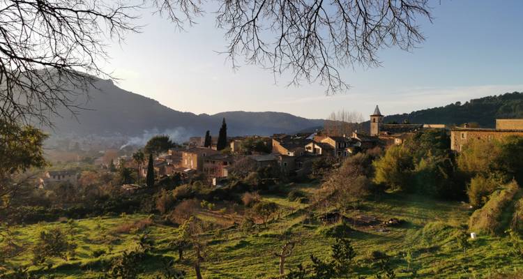 Charmant village avec vue sur les collines environnantes et la verdure.