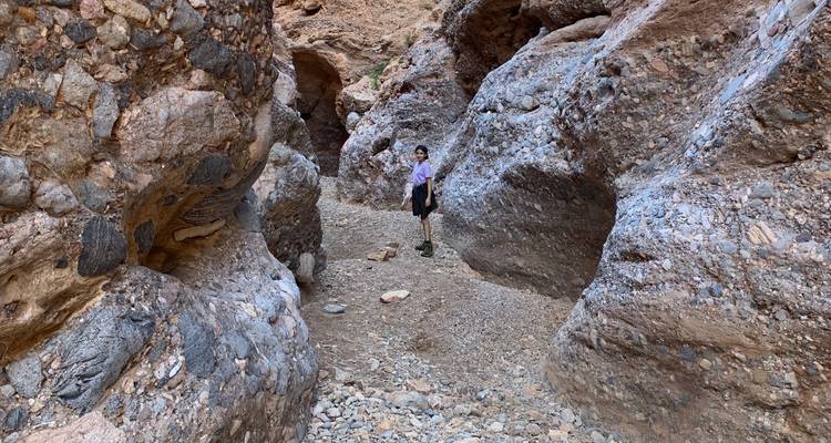 Person exploring a rocky canyon area.