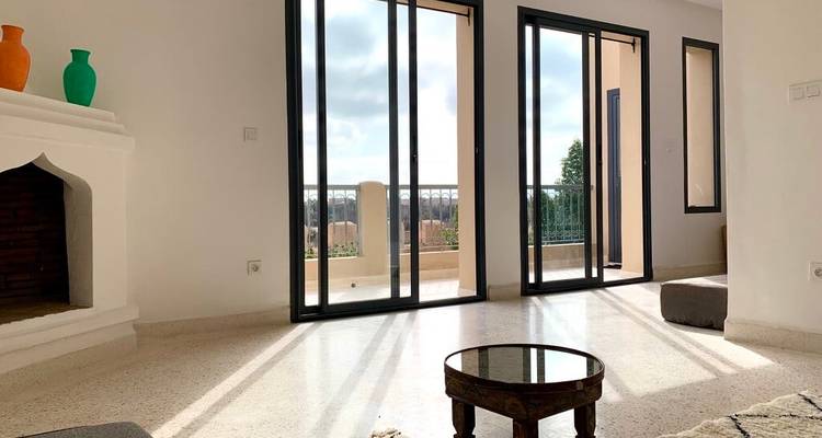 Modern interior space with large windows and minimal furnishings.