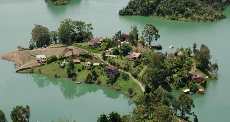 Aerial view of a small lush island community surrounded by a lake.
