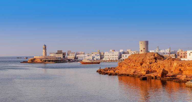 Beautiful coastal town with traditional architecture and a lighthouse.