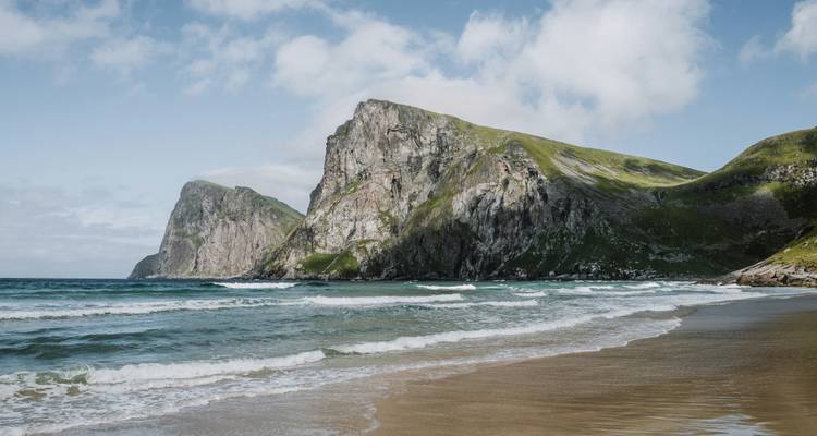 Picturesque beach with waves crashing on the shore.