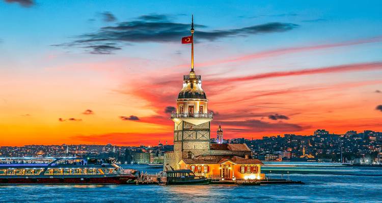 Scenic view of a tower by the water during sunset.