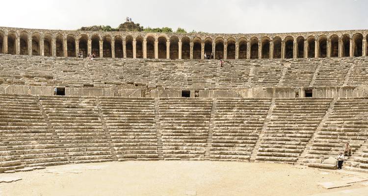 Ancient amphitheater with stone seating.