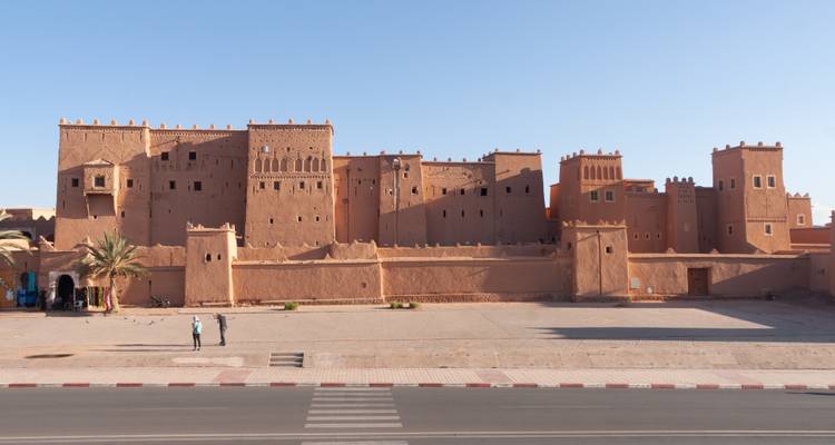 Large clay-walled structure on a sunny day.