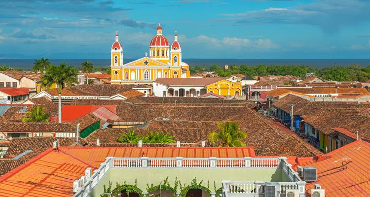 Vibrant colonial town with a cathedral in the center.