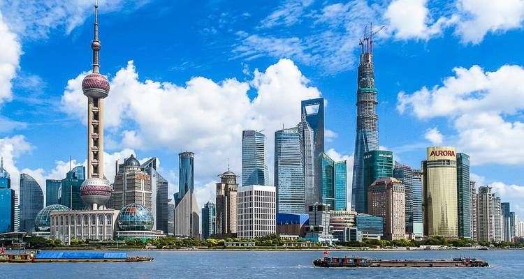 Shanghai skyline with modern skyscrapers and Huangpu River.