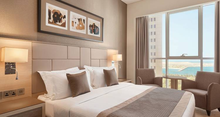 Elegant hotel room with a sea view and stylish furnishings.