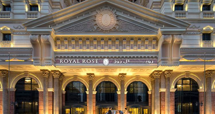 Grand hotel entrance with ornate architecture and warm lighting.