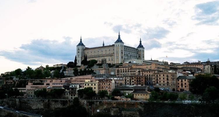 Exterior view of a large historic building on a hill.