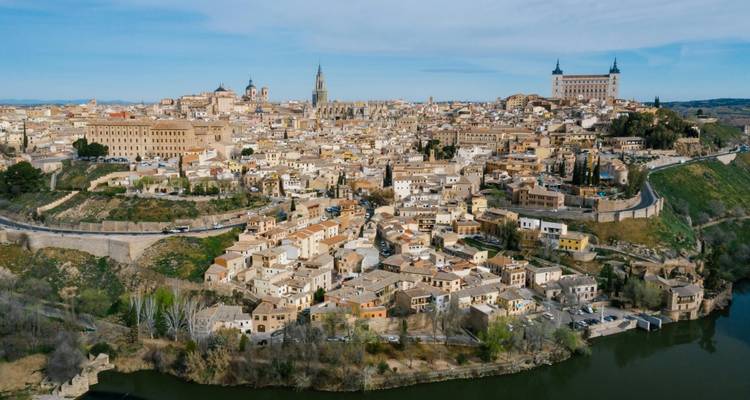 Panoramic view of a city with historical architecture and a river.